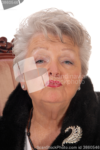 Image of Senior woman giving a kiss.