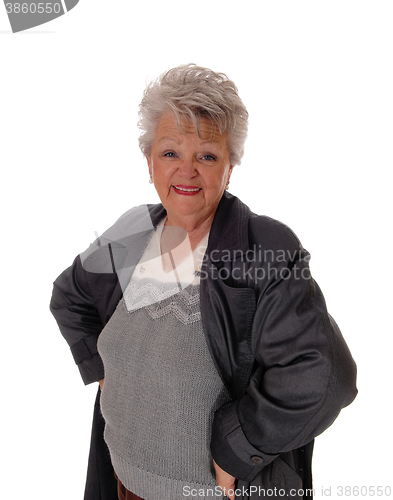 Image of Senior woman standing in a coat.