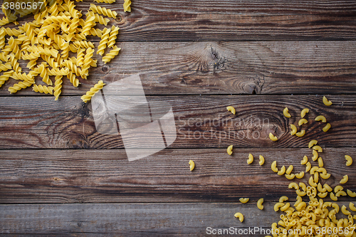 Image of Mixed dried pasta selection on wooden background.