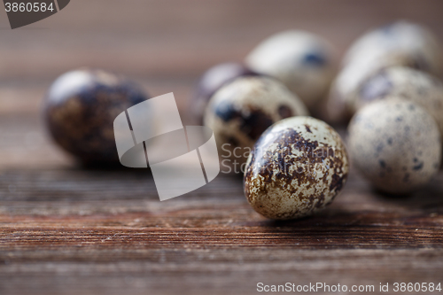 Image of Group of quail eggs on thewooden background