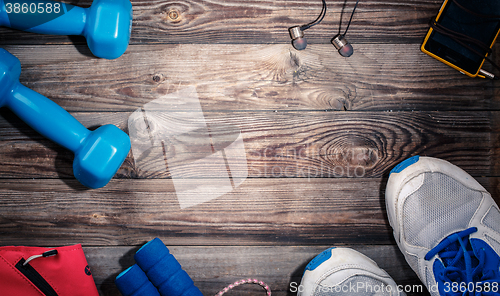 Image of Sport stuff on wooden table, top view