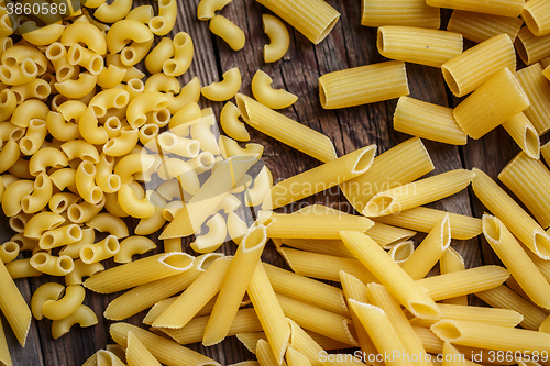 Image of close up portrait of raw homemade italian pasta, macaroni, spaghetti, and fettuccine