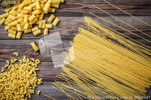 Image of close up portrait of raw homemade italian pasta, macaroni, spaghetti, and fettuccine