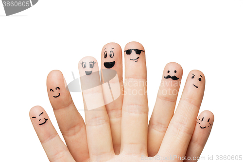 Image of close up of hands and fingers with smiley faces