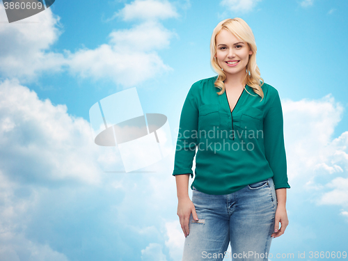 Image of smiling young woman in shirt and jeans