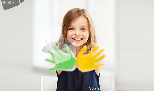 Image of girl showing painted hands