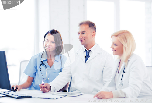 Image of doctors looking at computer on meeting