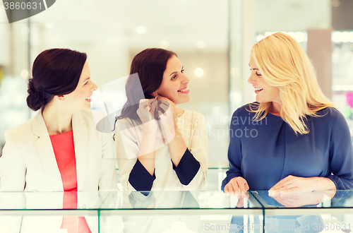 Image of happy women choosing earrings at jewelry store