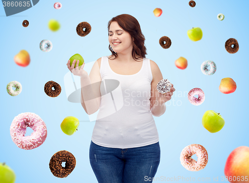 Image of happy plus size woman choosing apple or donut