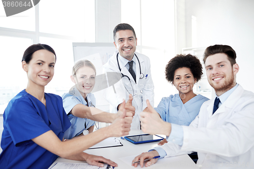 Image of group of doctors showing thumbs up at hospital