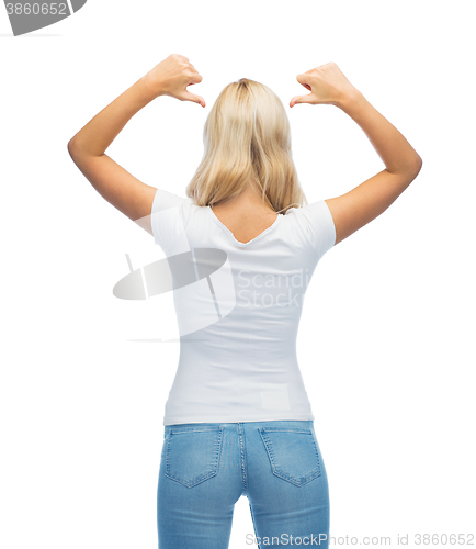 Image of rear view of young woman in blank white t-shirt