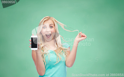 Image of happy young woman or teenage girl with smartphone