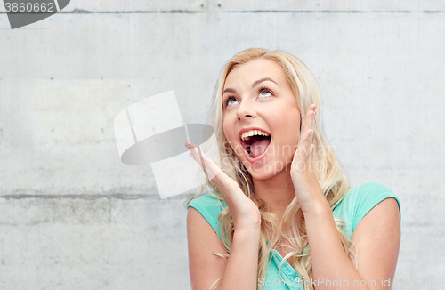 Image of surprised smiling young woman or teenage girl