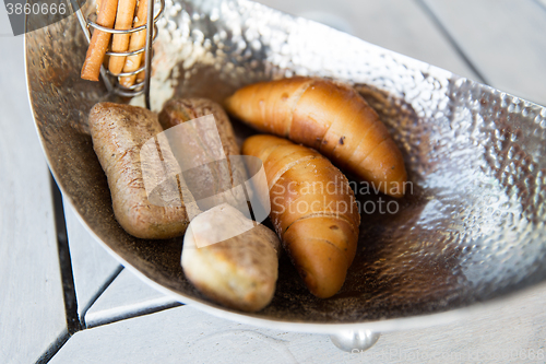 Image of close up of buns in bowl at cafe or bakery