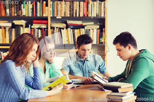 Image of students with books preparing to exam in library