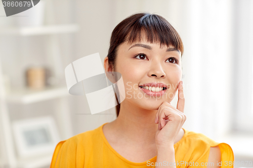 Image of happy asian young dreaming woman face at home