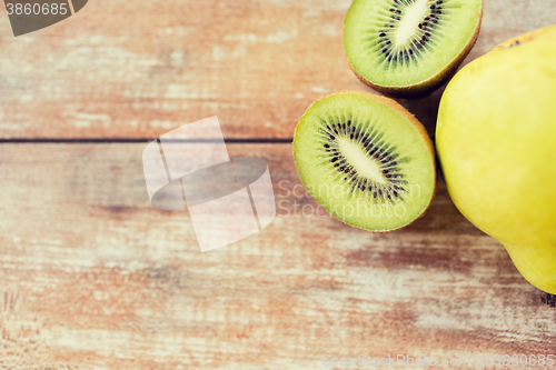 Image of close up of ripe kiwi and pear on table