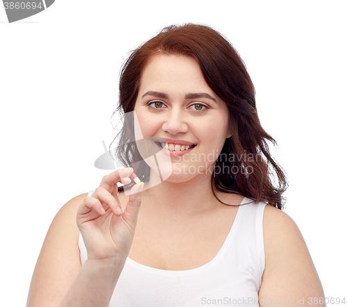 Image of happy plus size woman in underwear with pill