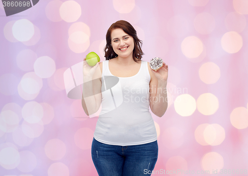 Image of happy plus size woman choosing apple or cookie