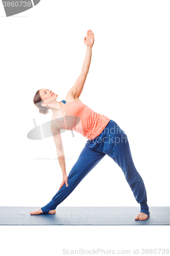 Image of Sporty fit woman practices yoga asana utthita trikonasana