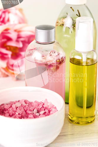 Image of Spa setting with pink roses and aroma oil, vintage style 