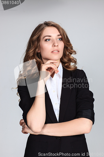 Image of The happy thoughtful woman on gray background