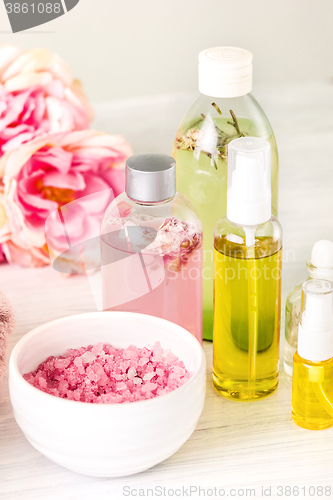 Image of Spa setting with pink roses and aroma oil, vintage style 