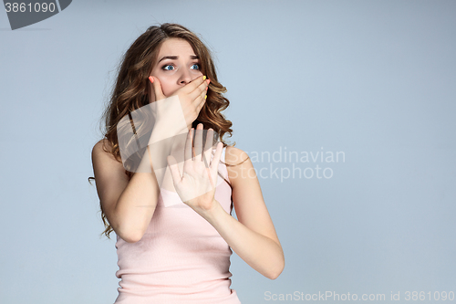 Image of Portrait of young woman with shocked facial expression