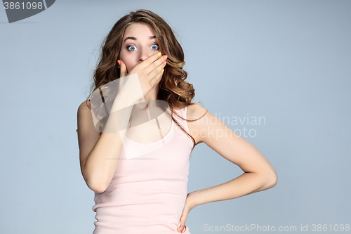 Image of Portrait of young woman with shocked facial expression