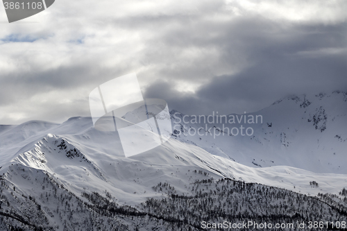 Image of Evening sunlight mountains and gray cloudy sky