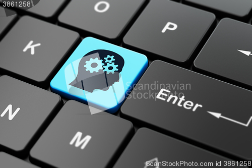 Image of Studying concept: Head With Gears on computer keyboard background