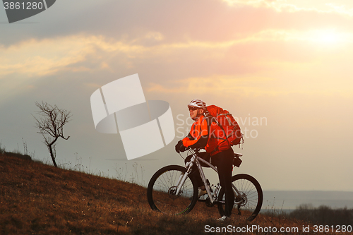 Image of Man cyclist with backpack riding the bicycle