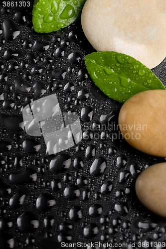 Image of zen stones on black with water drops