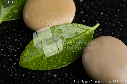 Image of zen stones on black with water drops