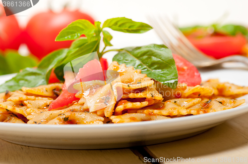 Image of Italian pasta farfalle butterfly bow-tie and tomato sauce