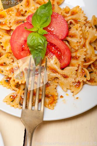 Image of Italian pasta farfalle butterfly bow-tie and tomato sauce