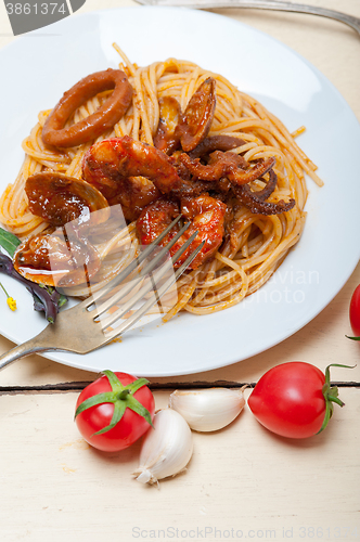 Image of Italian seafood spaghetti pasta on red tomato sauce 