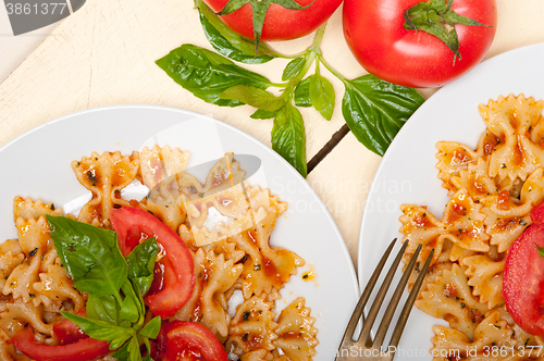 Image of Italian pasta farfalle butterfly bow-tie and tomato sauce