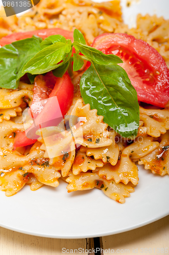 Image of Italian pasta farfalle butterfly bow-tie and tomato sauce