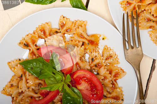 Image of Italian pasta farfalle butterfly bow-tie and tomato sauce