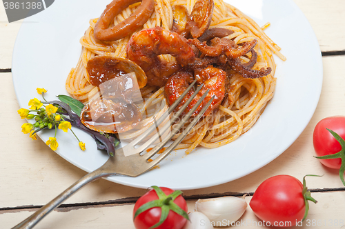 Image of Italian seafood spaghetti pasta on red tomato sauce 