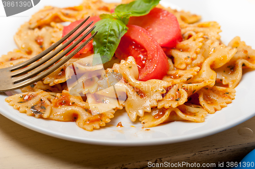 Image of Italian pasta farfalle butterfly bow-tie and tomato sauce