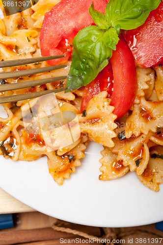 Image of Italian pasta farfalle butterfly bow-tie and tomato sauce