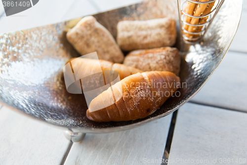 Image of close up of buns in bowl at cafe or bakery