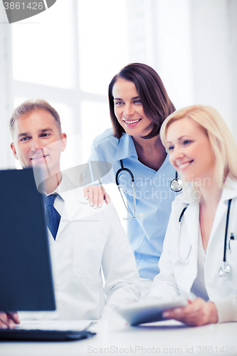 Image of doctors looking at computer on meeting