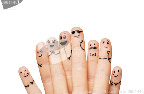 Image of close up of hands and fingers with smiley faces