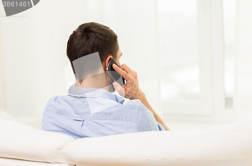 Image of close up of man calling on smartphone at home
