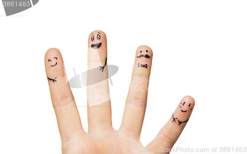 Image of close up of hands and fingers with smiley faces