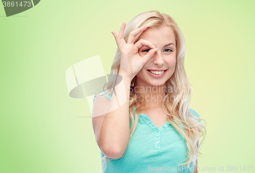 Image of young woman making ok hand gesture