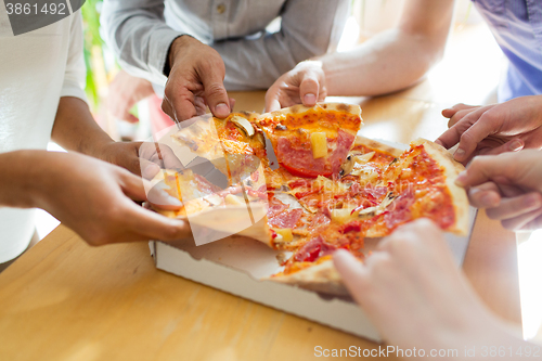 Image of close up of friends or people eating pizza